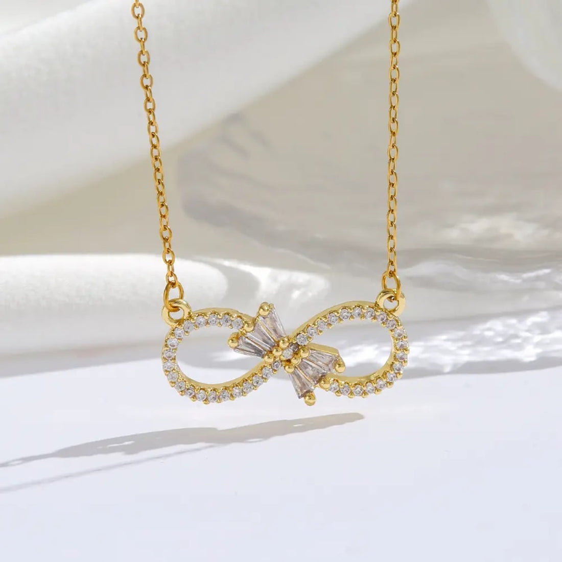 Infinity Bloom – Zircon Bow Necklace